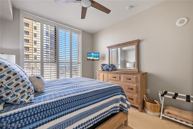 bedroom featuring carpet, ceiling fan, and multiple windows