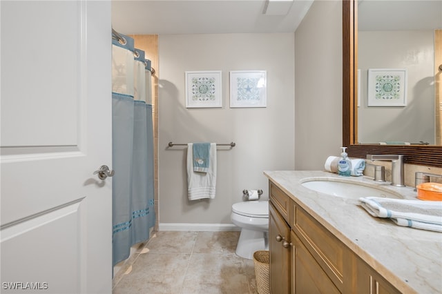 bathroom featuring tile patterned flooring, vanity, toilet, and walk in shower