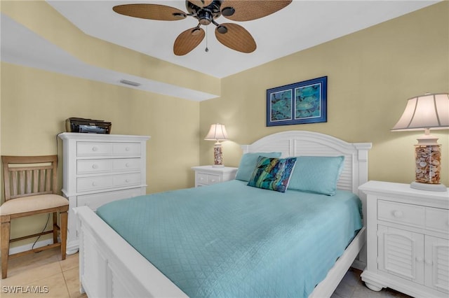 tiled bedroom featuring ceiling fan