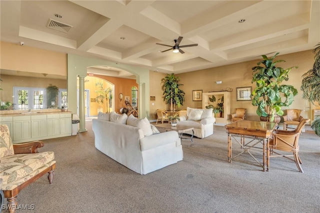 living room featuring beamed ceiling, light carpet, ceiling fan, and coffered ceiling