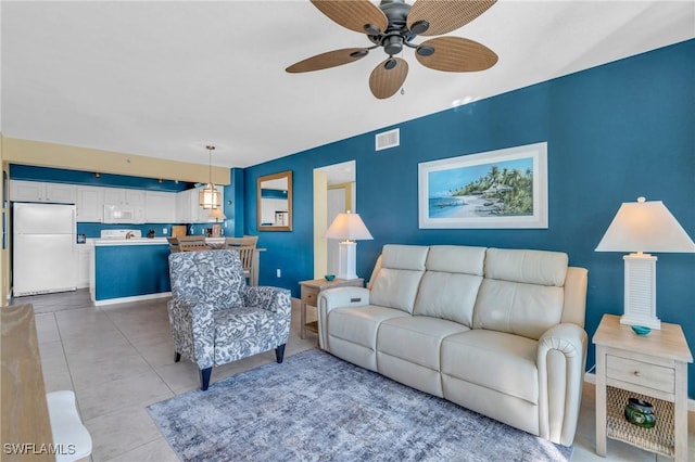 tiled living room featuring ceiling fan