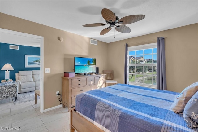 bedroom with ceiling fan and light tile patterned floors