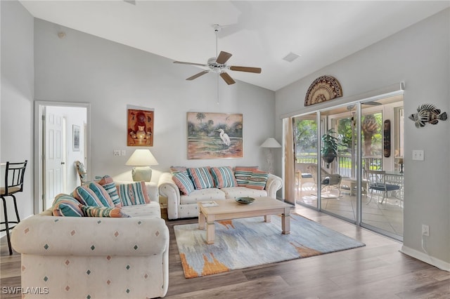 living room featuring ceiling fan, hardwood / wood-style floors, and lofted ceiling