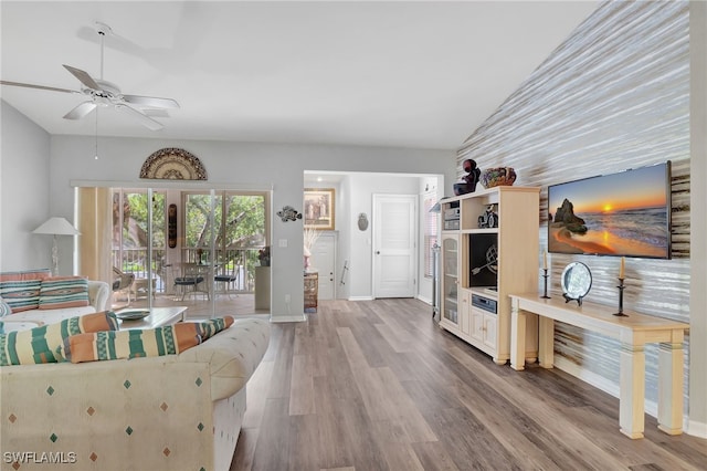 living room with ceiling fan, french doors, vaulted ceiling, and hardwood / wood-style flooring