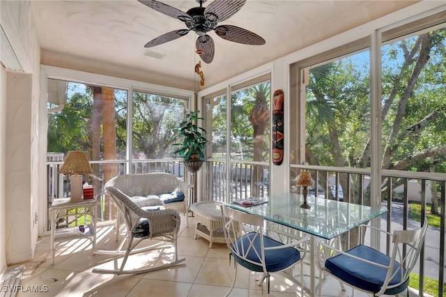 sunroom featuring ceiling fan and a wealth of natural light