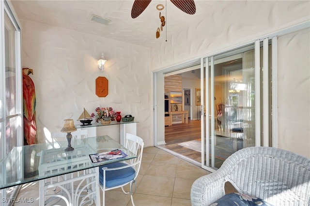 dining space with ceiling fan and light tile patterned flooring