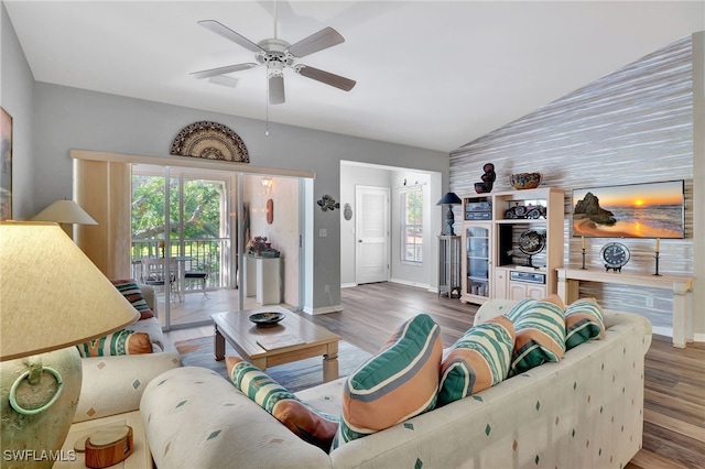 living room featuring ceiling fan, vaulted ceiling, and hardwood / wood-style floors