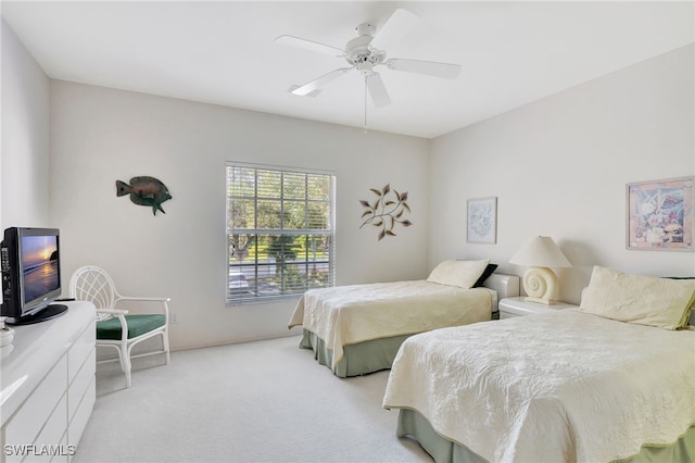 bedroom featuring ceiling fan and light carpet