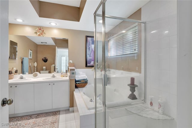 bathroom with plus walk in shower, tile patterned flooring, and vanity