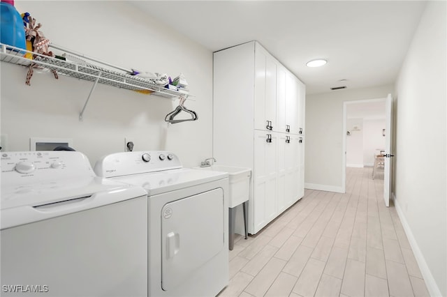 clothes washing area featuring washing machine and dryer and sink