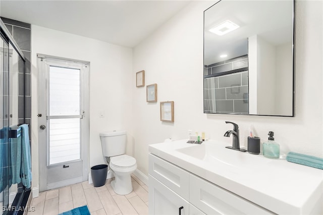 bathroom with vanity, toilet, and walk in shower