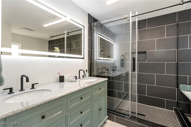 bathroom featuring tile patterned flooring, vanity, and walk in shower