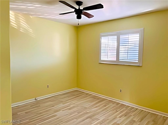 empty room with ceiling fan and light wood-type flooring