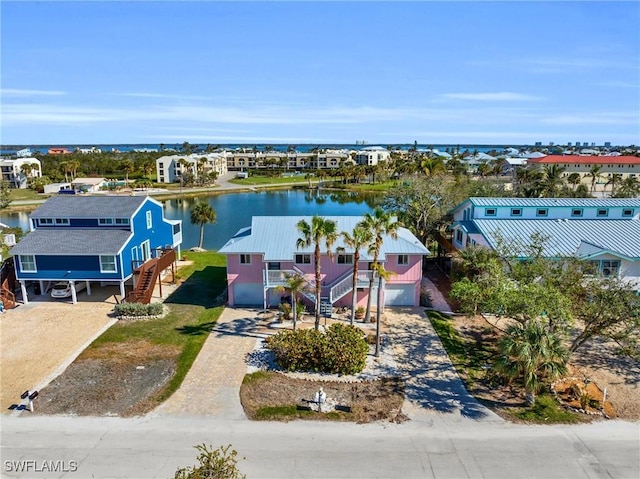 drone / aerial view featuring a water view and a residential view