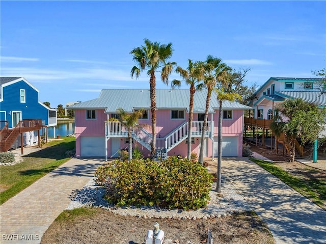 view of front of property with a water view and a garage