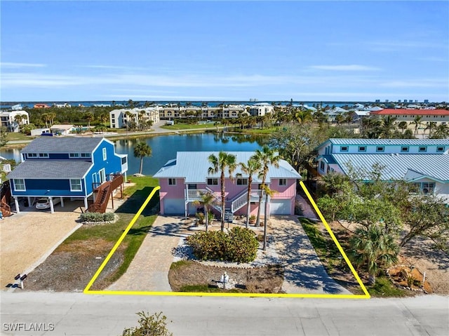 drone / aerial view featuring a residential view and a water view