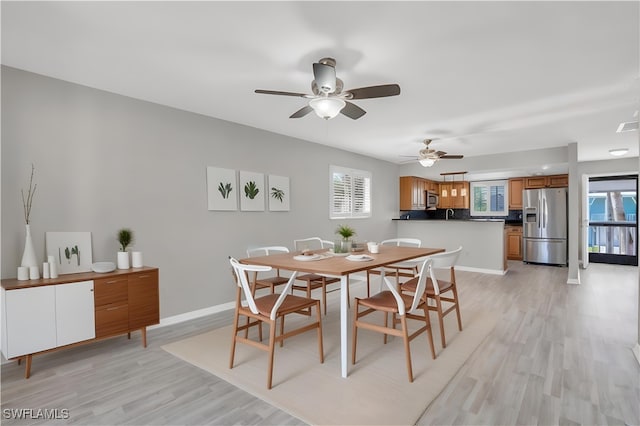 dining area with visible vents, ceiling fan, light wood-style flooring, and baseboards