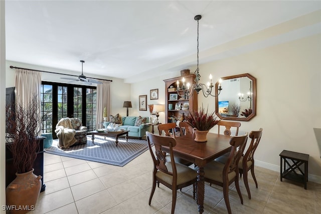 tiled dining room with french doors and ceiling fan with notable chandelier