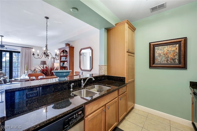 kitchen with sink, light tile patterned floors, decorative light fixtures, a notable chandelier, and dark stone countertops