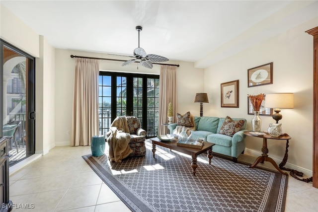 living room featuring ceiling fan, light tile patterned floors, and french doors