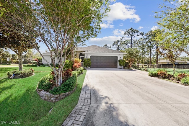 single story home featuring a front lawn and a garage