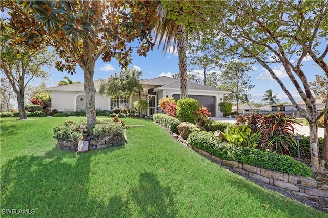 view of front facade with a front yard and a garage