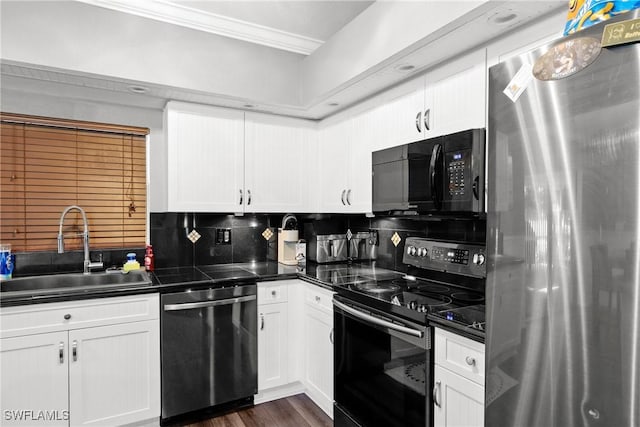 kitchen featuring decorative backsplash, sink, black appliances, dark hardwood / wood-style floors, and white cabinetry