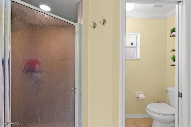 bathroom featuring an enclosed shower, toilet, crown molding, and tile patterned floors