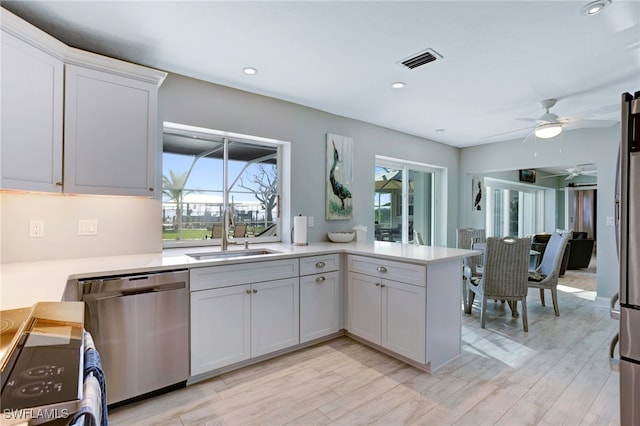 kitchen with stainless steel dishwasher, ceiling fan, and white cabinets