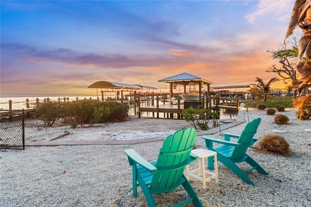 view of home's community featuring a boat dock and a water view