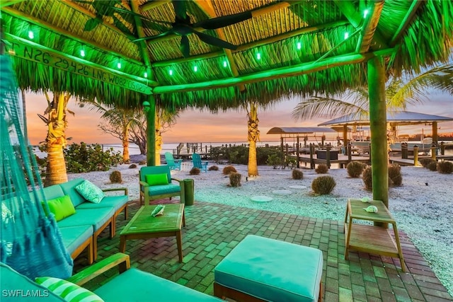 patio terrace at dusk featuring a gazebo and an outdoor hangout area