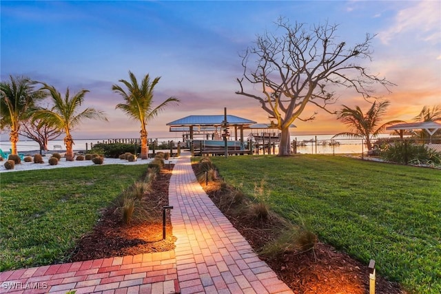 view of property's community featuring a yard and a water view