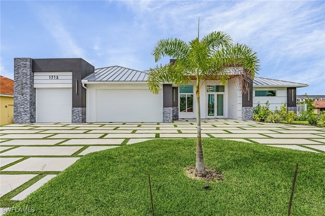 view of front of property with a garage and a front yard