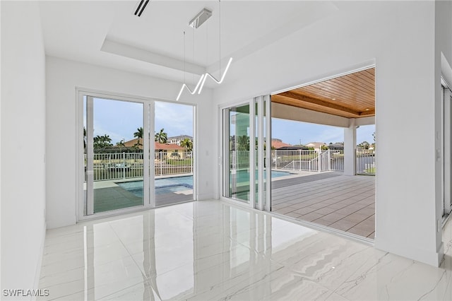 interior space featuring wood ceiling and a tray ceiling