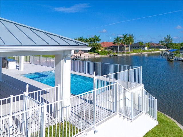 view of swimming pool featuring a patio area and a water view