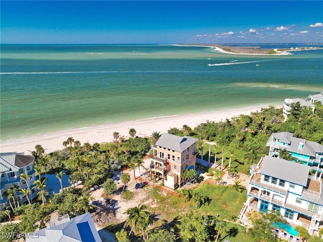 drone / aerial view featuring a water view and a beach view