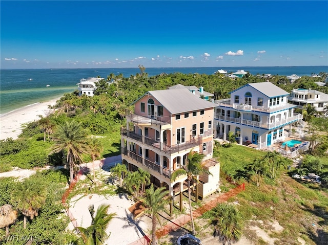 aerial view with a water view and a beach view