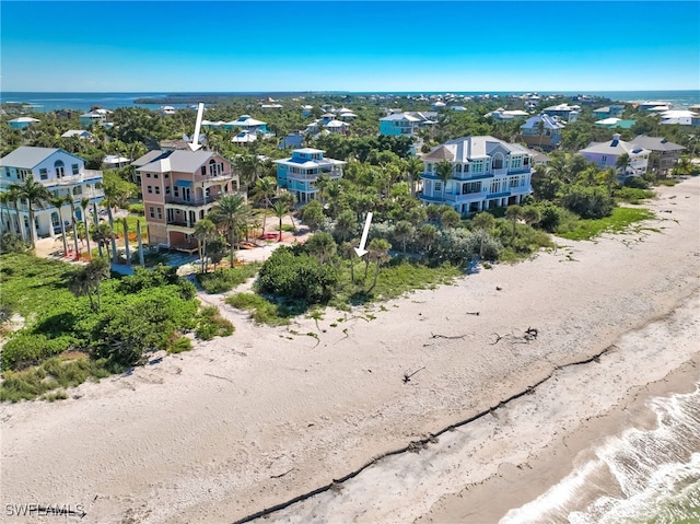 drone / aerial view featuring a water view and a beach view