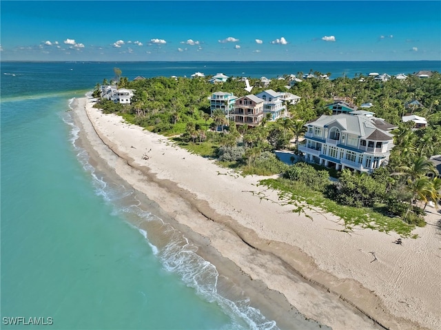 birds eye view of property with a view of the beach and a water view