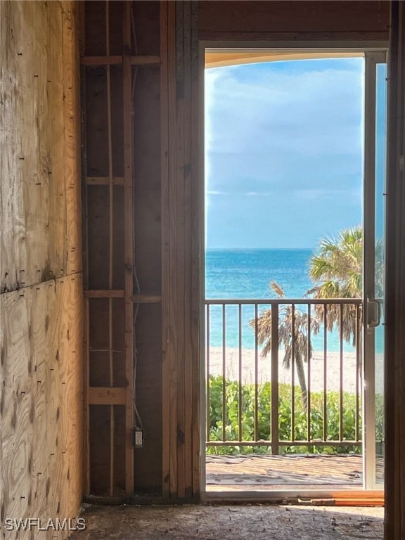 balcony with a water view and a beach view