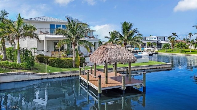 view of dock featuring a water view and a balcony