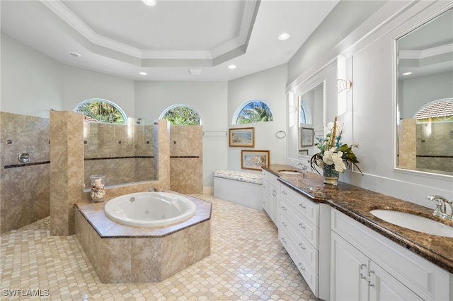 bathroom featuring vanity, a raised ceiling, crown molding, tile patterned flooring, and a relaxing tiled tub