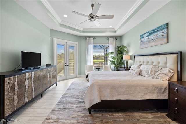 bedroom featuring access to outside, a raised ceiling, ceiling fan, and french doors