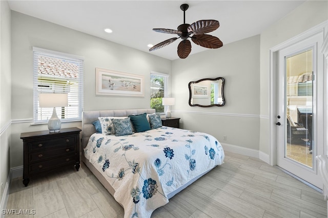 bedroom with multiple windows, ceiling fan, and access to exterior