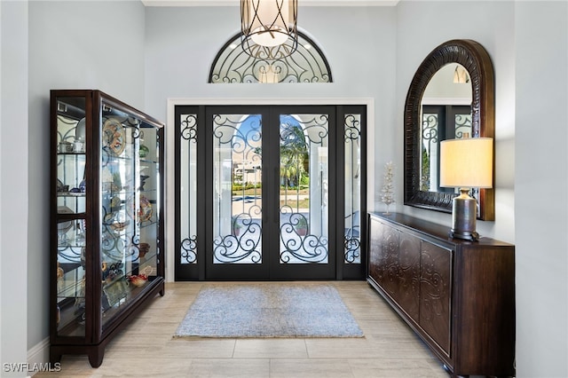 entrance foyer featuring french doors and light hardwood / wood-style flooring