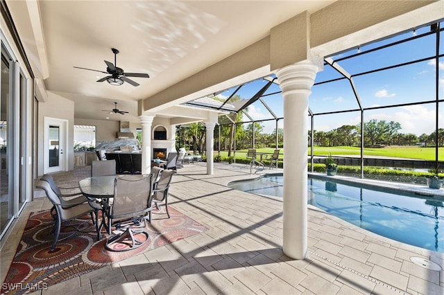 view of patio with ceiling fan and a lanai