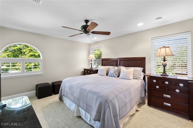 bedroom featuring ceiling fan and light carpet