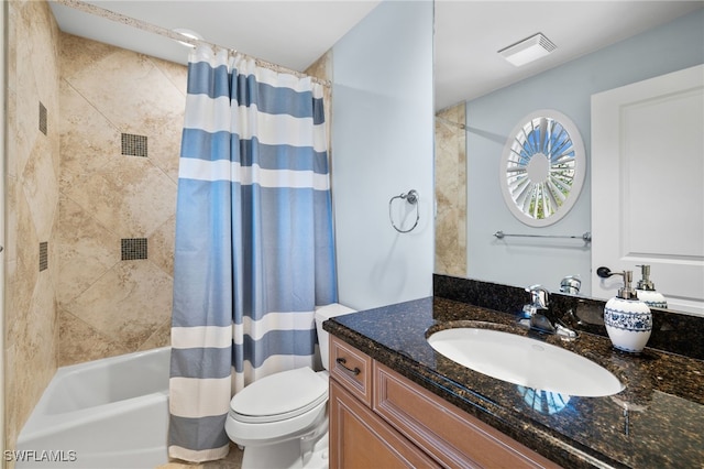 full bathroom featuring vanity, shower / bath combo, and toilet