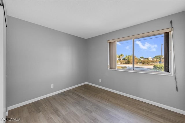 unfurnished room featuring hardwood / wood-style floors