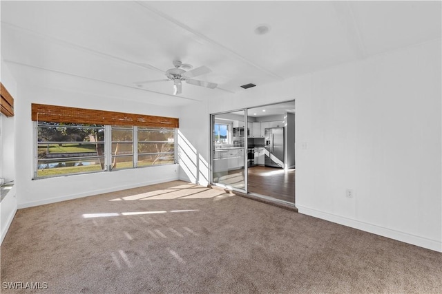 unfurnished living room with carpet flooring and ceiling fan